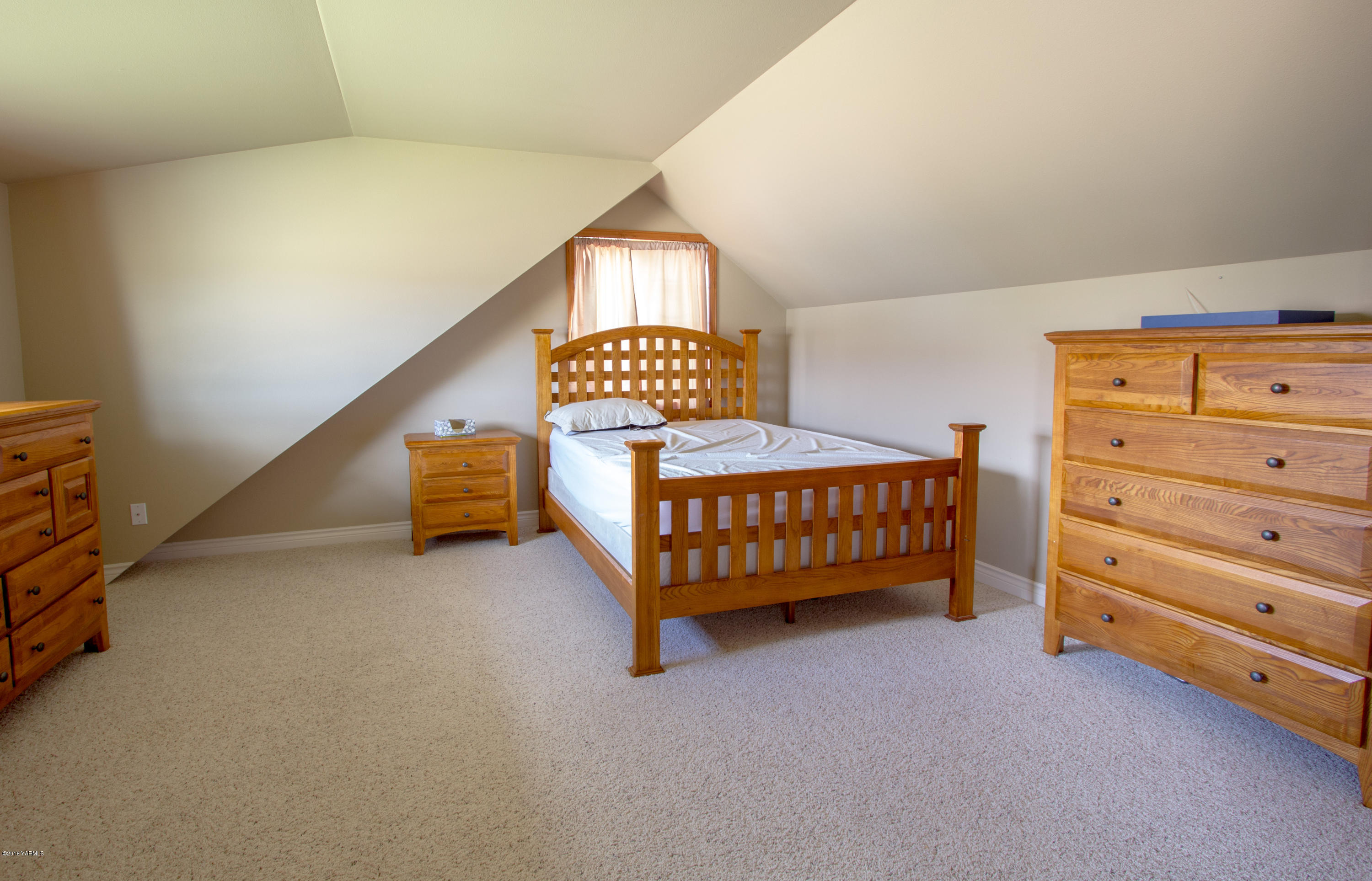 491 Section 1 Road Tieton, WA 98947 - Photo 18 of 23 a bedroom with a bed and a lamp on dresser
