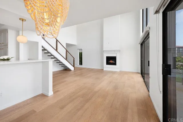a view of a livingroom with wooden floor and stairs