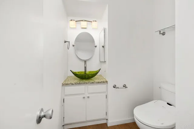 a bathroom with a toilet a sink and mirror
