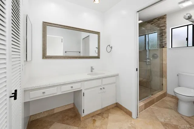 a bathroom with a toilet sink and shower
