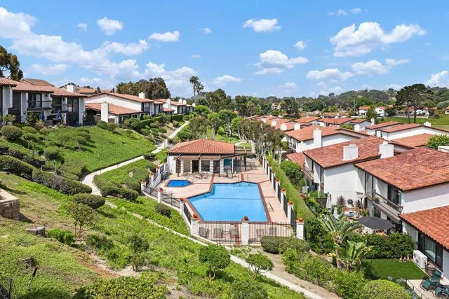 an aerial view of a house with a garden and lake view