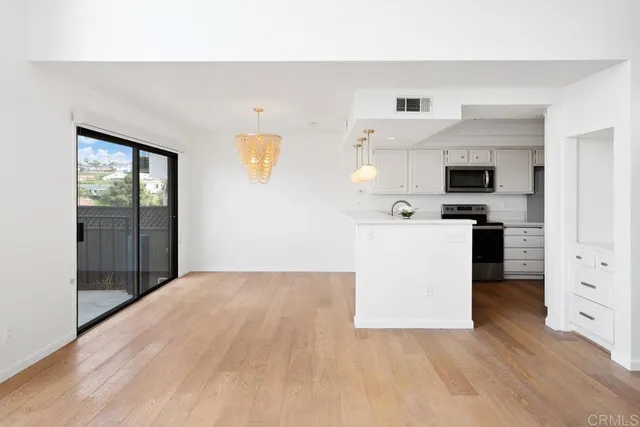 a view of a kitchen with microwave and cabinets