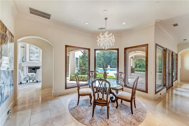 a view of a dining room with furniture wooden floor and chandelier