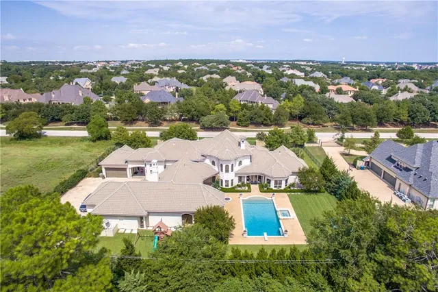 an aerial view of house with yard swimming pool and outdoor seating