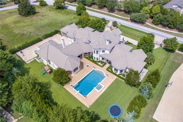 an aerial view of a house with outdoor space and pool