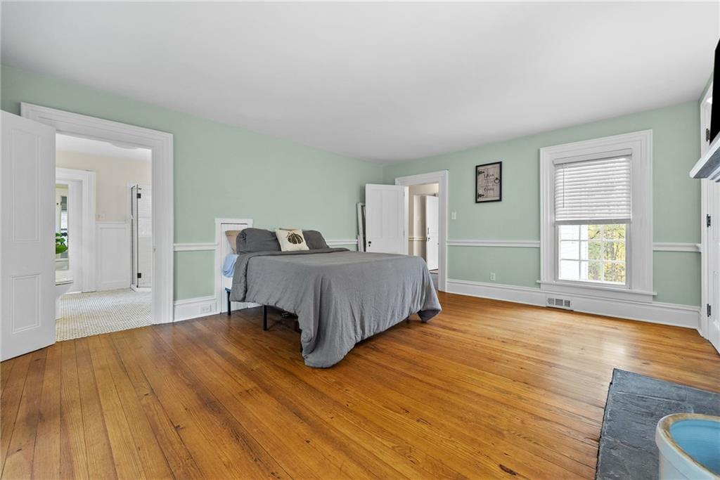 755 South Main Street Washington, PA 15301 - Photo 31 of 44 a spacious bedroom with a bed and wooden floor