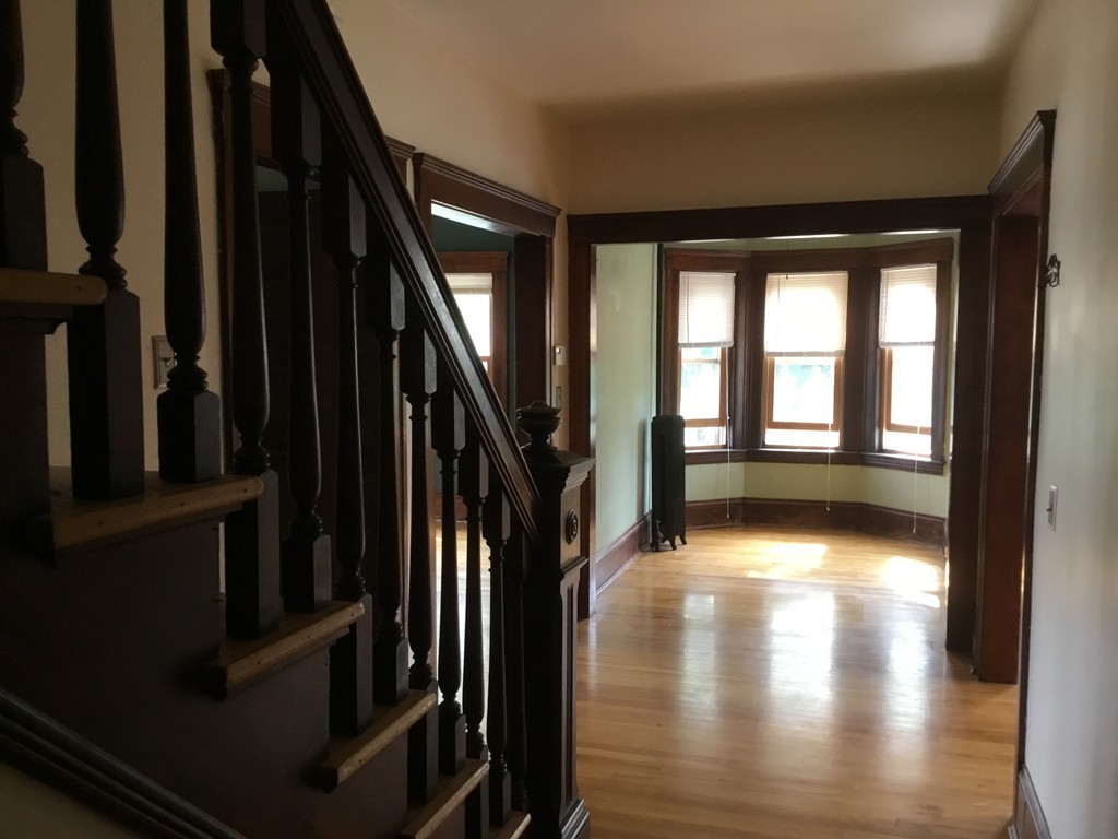 53 Brighton Road Worcester, MA 01606 - Photo 4 of 22 a view of a hallway with wooden floor and stairs