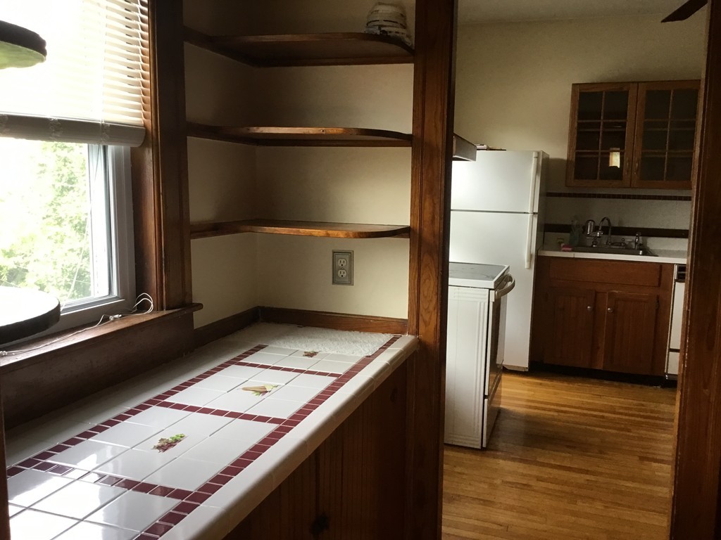 53 Brighton Road Worcester, MA 01606 - Photo 10 of 22 a kitchen with a refrigerator and a stove