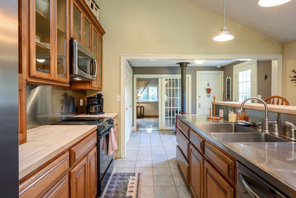 34 Clapp Street Abington, MA 02351 - Photo 4 of 21 a kitchen with stainless steel appliances granite countertop a sink and a stove