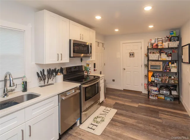 a kitchen with stainless steel appliances granite countertop a stove and a sink
