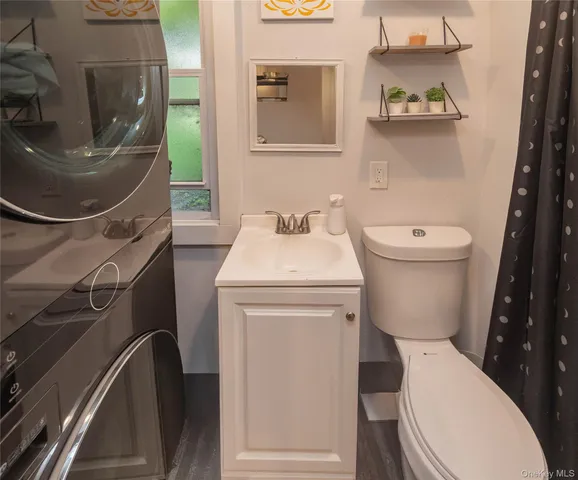a white toilet sitting next to a sink and a mirror