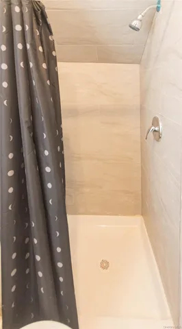 a bedroom with bed and a large window