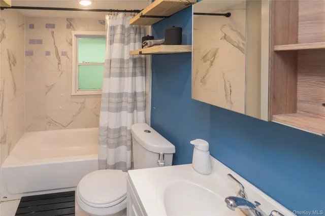 a bathroom with a shower curtain and a sink