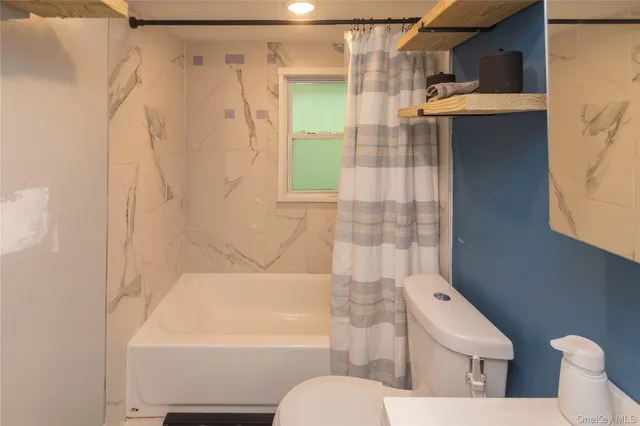 a view of livingroom with furniture and baby crib