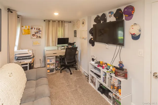 a view of a livingroom with workspace and a couch