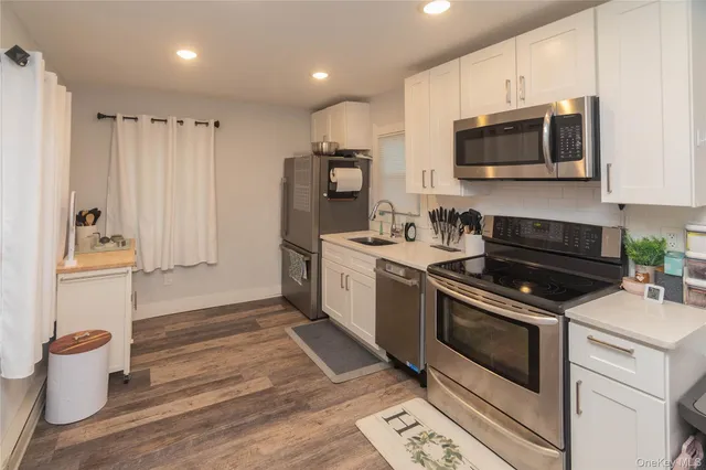 a kitchen with a sink stove and microwave