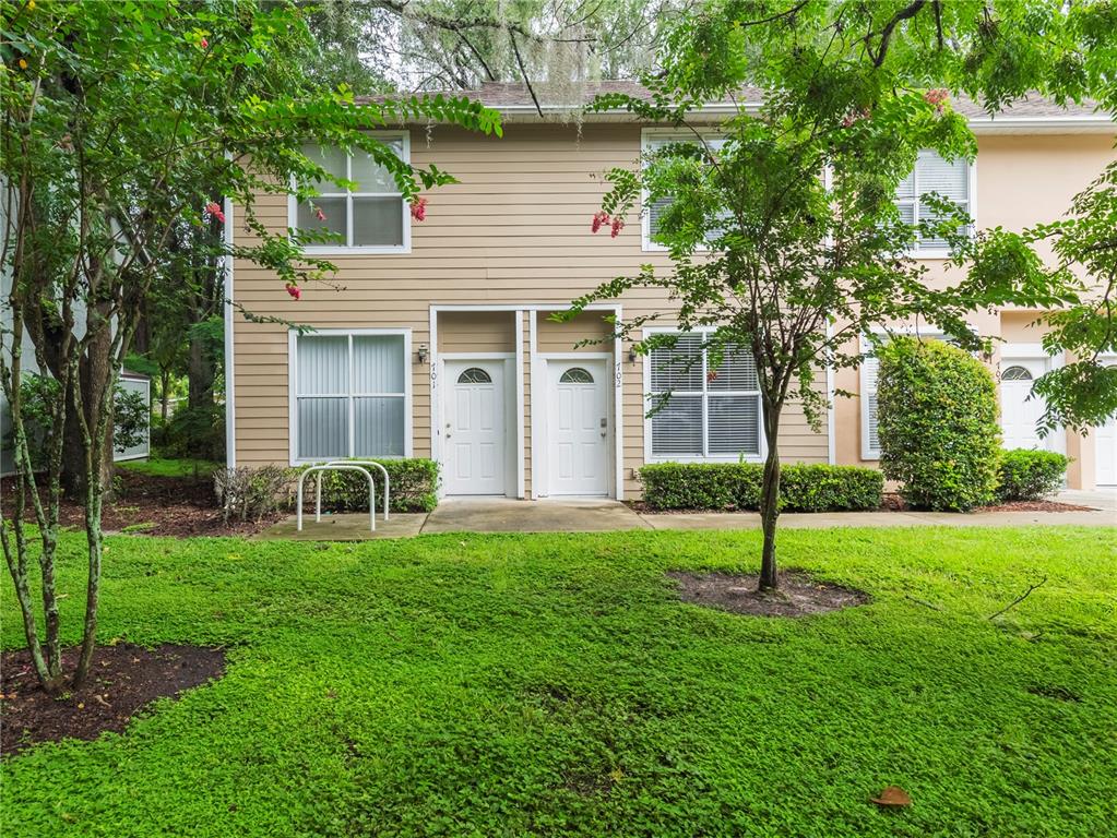 4415 Southwest 34th Street, Unit 702 Gainesville, FL 32608 - Photo 1 of 1 a view of a house with a yard and sitting area