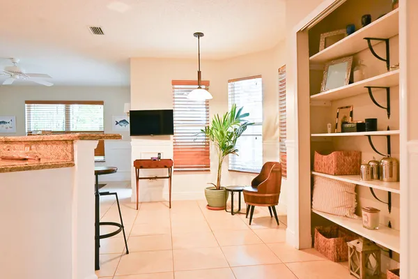a living room with furniture a flat screen tv and next to a window