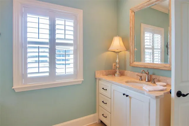 a bathroom with a sink vanity and a mirror
