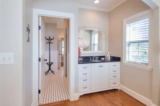 wooden floor with cabinet and mirror