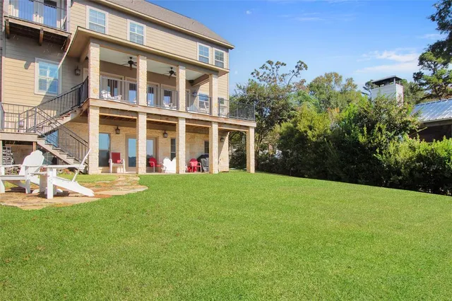 a view of a house with backyard porch and sitting area
