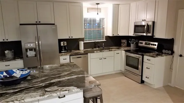 a stove top oven sitting inside of a kitchen