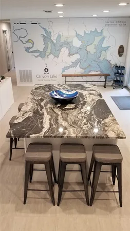 a bed sitting in a bedroom and mirror with wooden floor