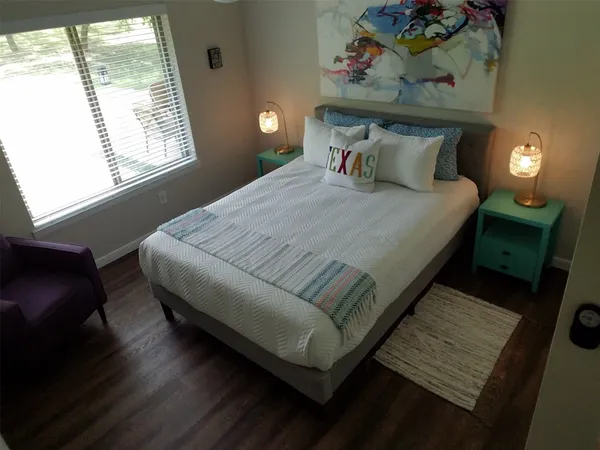 a bed sitting in a bedroom next to a window