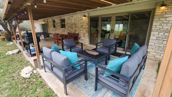 a living room with furniture and a floor to ceiling window