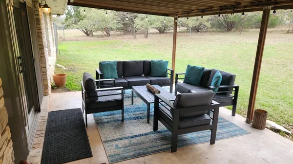 a view of balcony with outdoor seating and trees