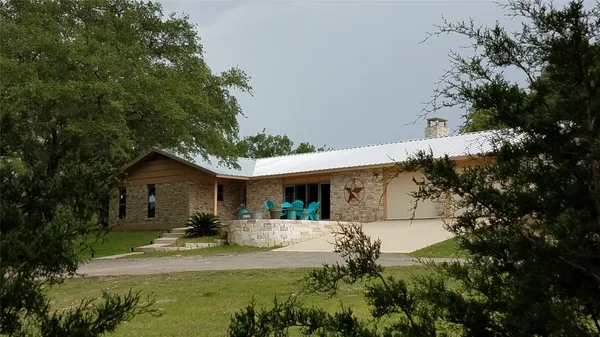 a view of a backyard with sitting area