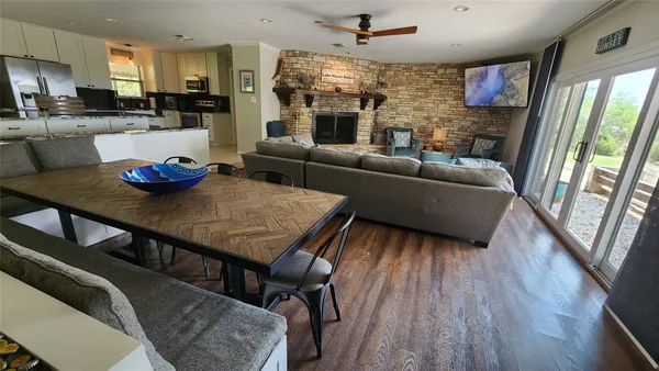 a living room with furniture wooden floor and a fireplace