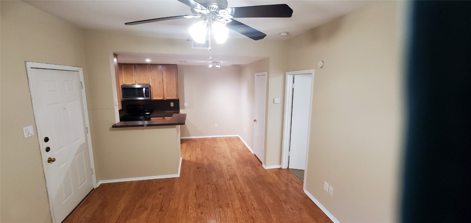 114 East 31st Street, Unit 114 Austin, TX 78705 - Photo 2 of 11 wooden floor in an empty room with a window