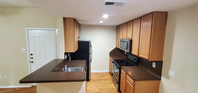 a kitchen with stainless steel appliances kitchen island a stove and a refrigerator