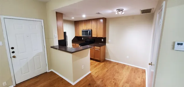 a kitchen with a refrigerator and a stove top oven
