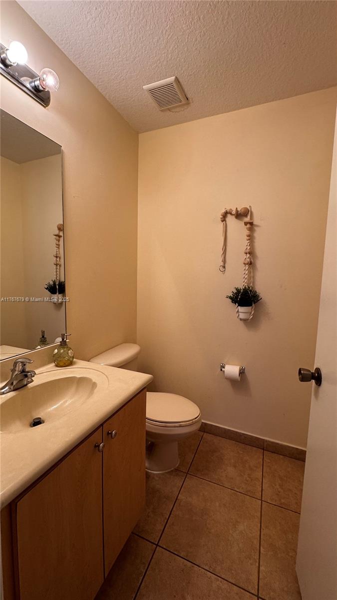 1033 Southwest 144th Avenue, Unit 2705 Pembroke Pines, FL 33027 - Photo 12 of 28 a bathroom with a sink a toilet and mirror
