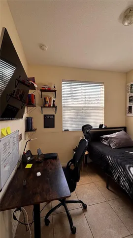 a room with furniture gym equipment and windows