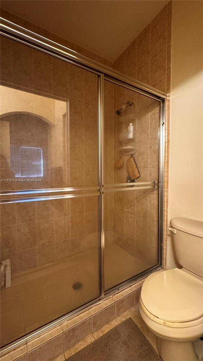 1033 Southwest 144th Avenue, Unit 2705 Pembroke Pines, FL 33027 - Photo 24 of 28 a bathroom with a toilet and a shower