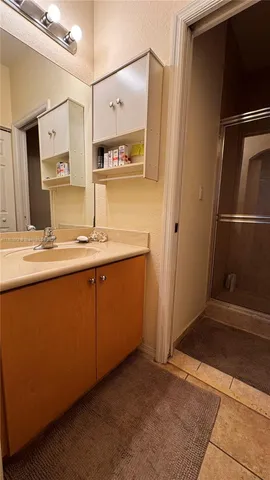 a view of a hallway with wooden shelves