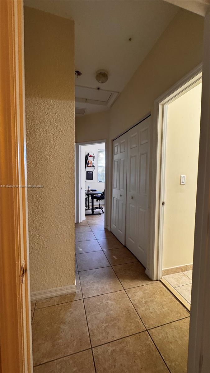 1033 Southwest 144th Avenue, Unit 2705 Pembroke Pines, FL 33027 - Photo 26 of 28 a view of a hallway with wooden shelves
