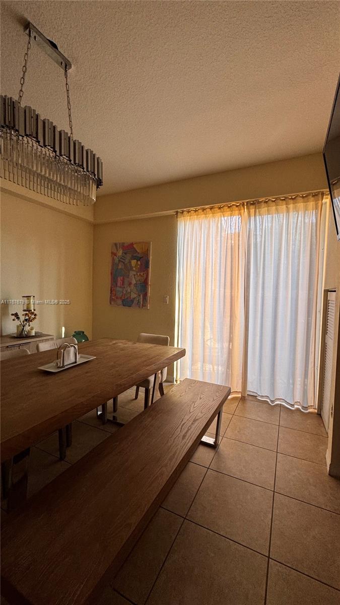 1033 Southwest 144th Avenue, Unit 2705 Pembroke Pines, FL 33027 - Photo 10 of 28 a room with gym equipment and large window