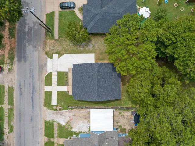 aerial view of a house with a yard