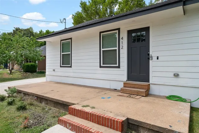a backyard of a house with plants and trees