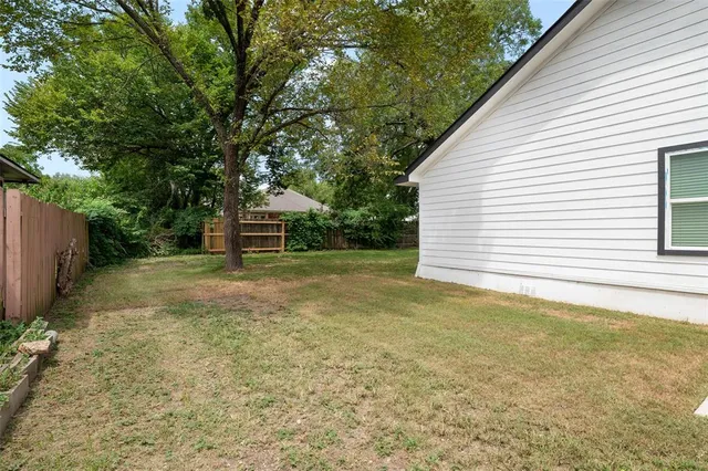 a backyard of a house with table and chairs