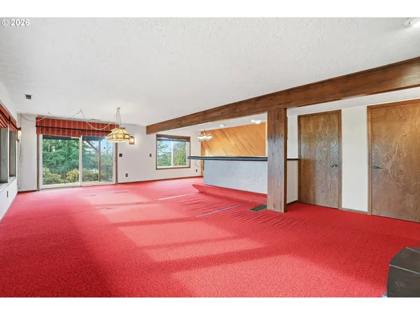 a room with a bed and a large window