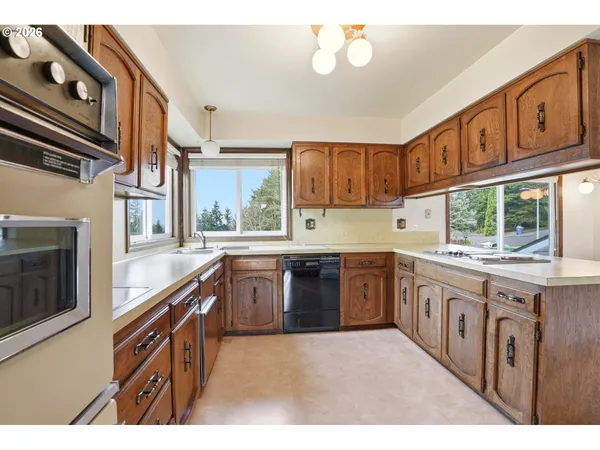 a kitchen with stainless steel appliances granite countertop a stove and cabinets