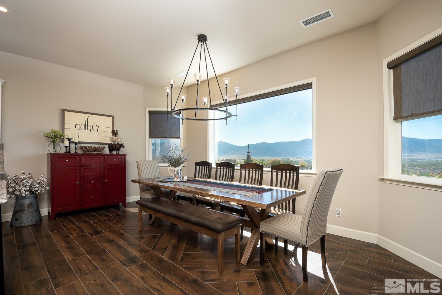 Undisclosed Address Minden, NV 89423 - Photo 11 of 33 a view of a dining room with furniture a chandelier and wooden floor