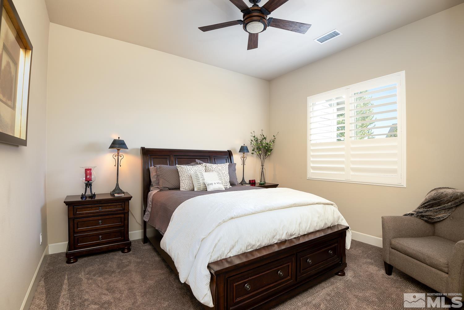 Undisclosed Address Minden, NV 89423 - Photo 18 of 33 a bedroom with a bed and ceiling fan