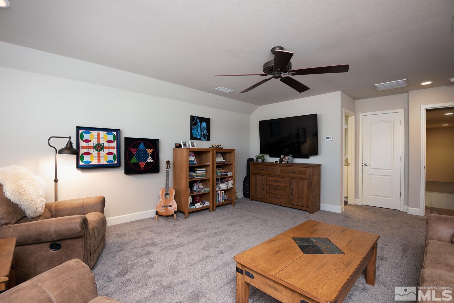 Undisclosed Address Minden, NV 89423 - Photo 23 of 33 a living room with furniture and a flat screen tv