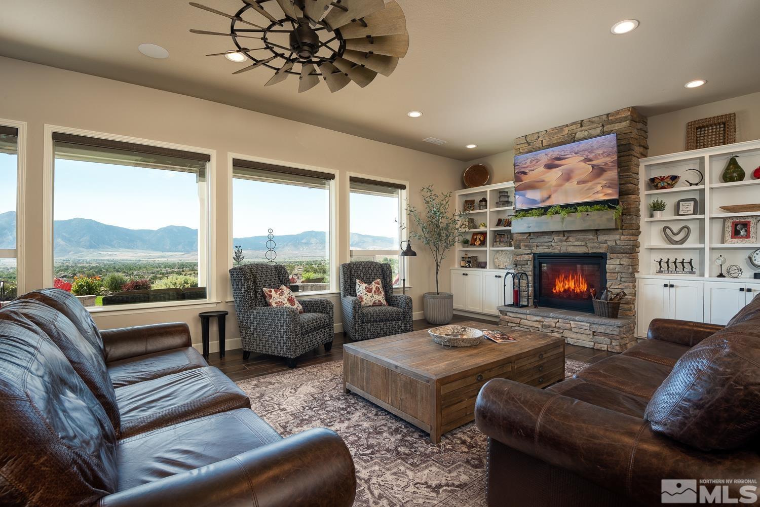 Undisclosed Address Minden, NV 89423 - Photo 6 of 33 a living room with furniture large window and a fireplace